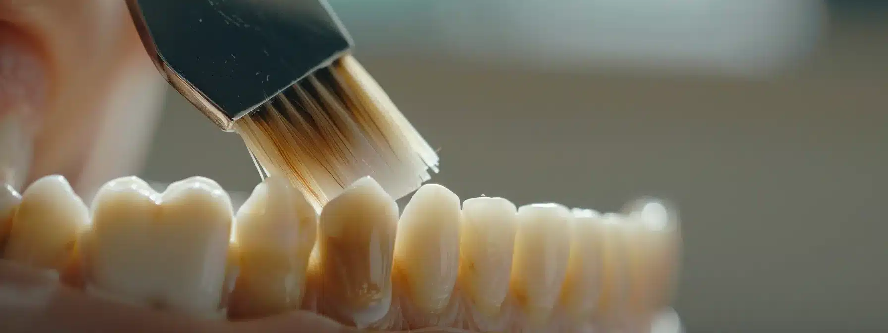 a person carefully brushing around their dental implant with precision and attention to detail.