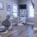 a smiling patient receiving affordable emergency dental care in a modern, clean clinic in tyler, tx.