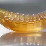 a close-up photo featuring a gleaming dental implant anchored securely into the jawbone, showcasing its durability and stability.