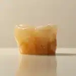 a gleaming dental implant with a perfectly fitted crown sitting on a pristine white background.