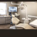 a modern dental chair with a bright overhead light, ready for a low cost root canal and crown procedure.