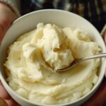 a person enjoying a smooth and comforting bowl of creamy mashed potatoes after a tooth extraction.