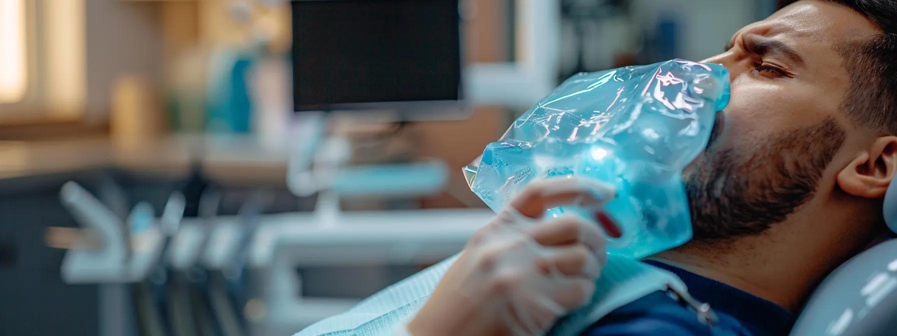 a person in crowley, tx, holding an ice pack to their jaw after a root canal procedure, with a dental office sign in the background.