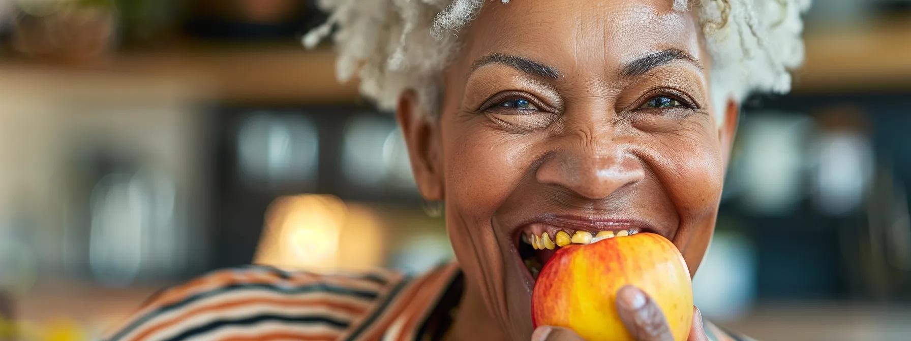 a smiling individual confidently biting into an apple with secure snap-in dentures, showcasing comfort and stability.