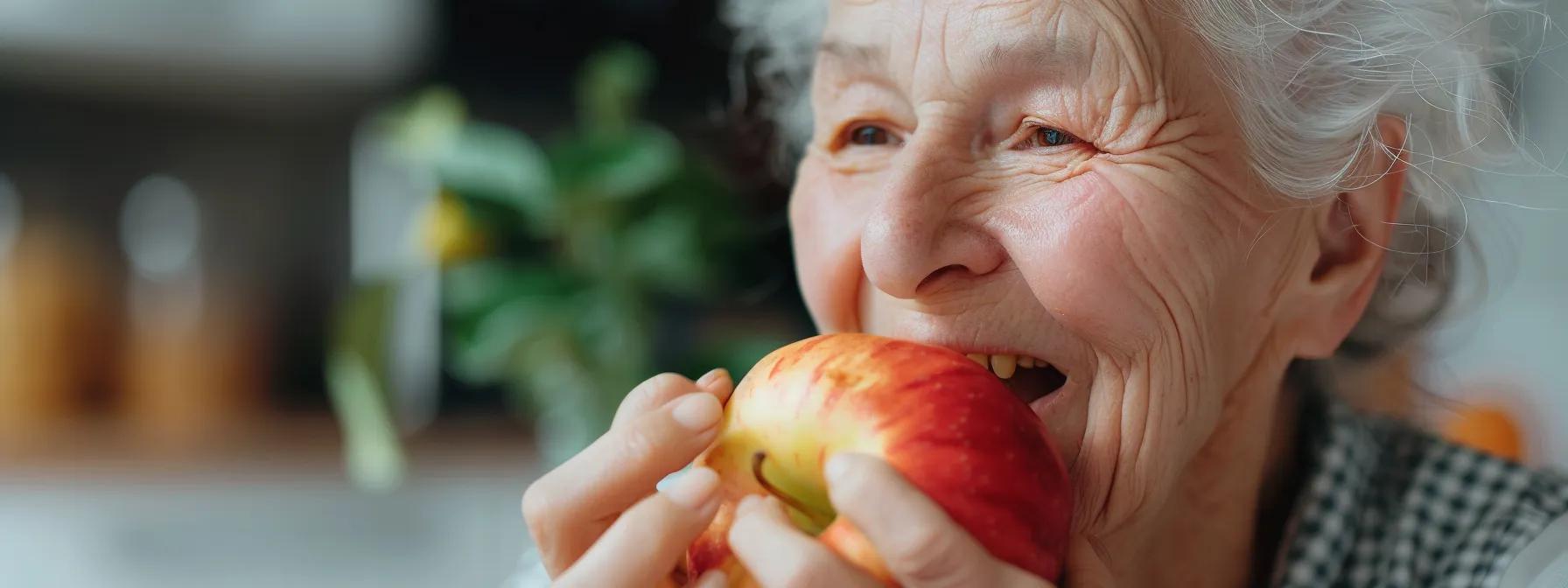 a smiling individual confidently eating a crunchy apple with ease, showcasing the secure fit and stability of snap-in dentures.