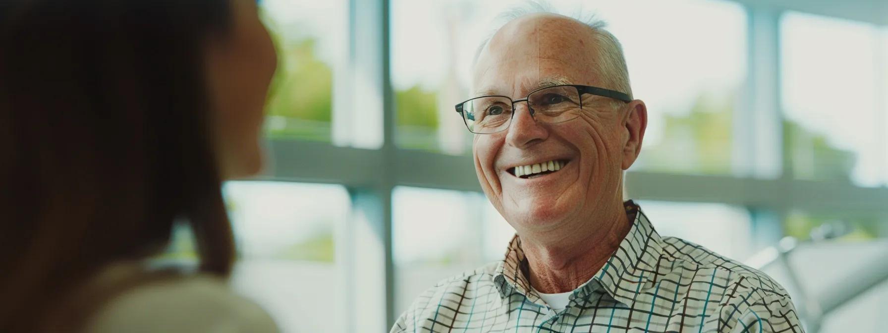 a smiling patient discussing insurance coverage options with a fort worth dental specialist in a modern, brightly lit office.