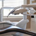 a dentist carefully performing a root canal procedure on a patient's tooth using precise instruments, with a focus on the intricate dental work being done.