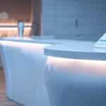 a close-up shot of a dental clinic's serene reception area, featuring a sleek modern desk with soft, diffused lighting that highlights a prominently displayed informational brochure about wisdom tooth extraction charges, creating a calm and professional atmosphere.