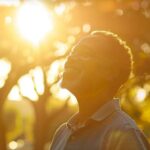 a radiant smile of a senior enjoying a sunlit park, showcasing vibrant dental implants that enhance their natural beauty and confidence.