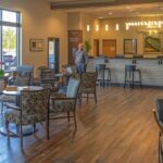 a serene dental clinic in fort worth, bathed in soft, natural light, showcases a confident patient consulting with a compassionate dentist about innovative solutions for dental implant failure, highlighting professionalism and hope.