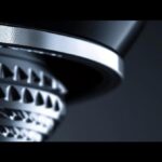 a stunning close-up of a gleaming dental implant set against a contrasting matte surface, highlighting its durability and modern design, with soft, diffused lighting that accentuates its intricate details.