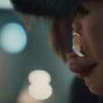 a focused close-up of a concerned patient gazing into a dental mirror, reflecting vibrant hues of dental tools and a slightly blurred dental office background, capturing the tension and urgency of recognizing dental implant failure symptoms.