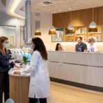 a radiant dental clinic, featuring a confident patient consulting with a knowledgeable dentist against a backdrop of modern, state-of-the-art equipment.