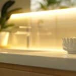 a radiant, softly lit dental clinic showcasing a gleaming dental implant model on a smooth countertop, symbolizing advanced oral health care and patient confidence.