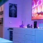 a close-up shot of a modern dental clinic showcasing a sleek dental implant model surrounded by vibrant, high-tech equipment, illuminated by soft, inviting lighting that emphasizes the innovative alternatives in dental care.