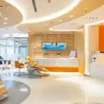 a confident patient sits in a modern dental clinic, surrounded by advanced technology and soothing colors, as an experienced implant dentist explains the procedure with a reassuring smile.