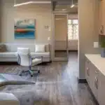 a serene dental clinic setting featuring a pristine dental chair surrounded by soft, natural light that highlights essential aftercare tools for successful implant recovery.