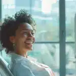 a serene dental office environment featuring a confident patient smiling widely, showcasing a flawless dental implant, illuminated by soft, natural light streaming through large windows, symbolizing successful recovery and new beginnings.