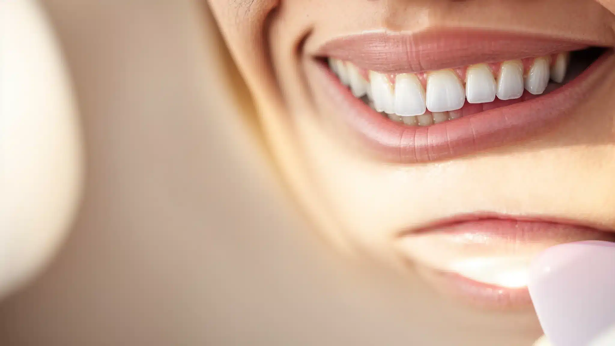a close-up of a beautifully restored smile featuring a high-quality dental crown, illuminated by soft, natural lighting to emphasize its aesthetic brilliance and the promise of dental health in a welcoming dentist's office setting.