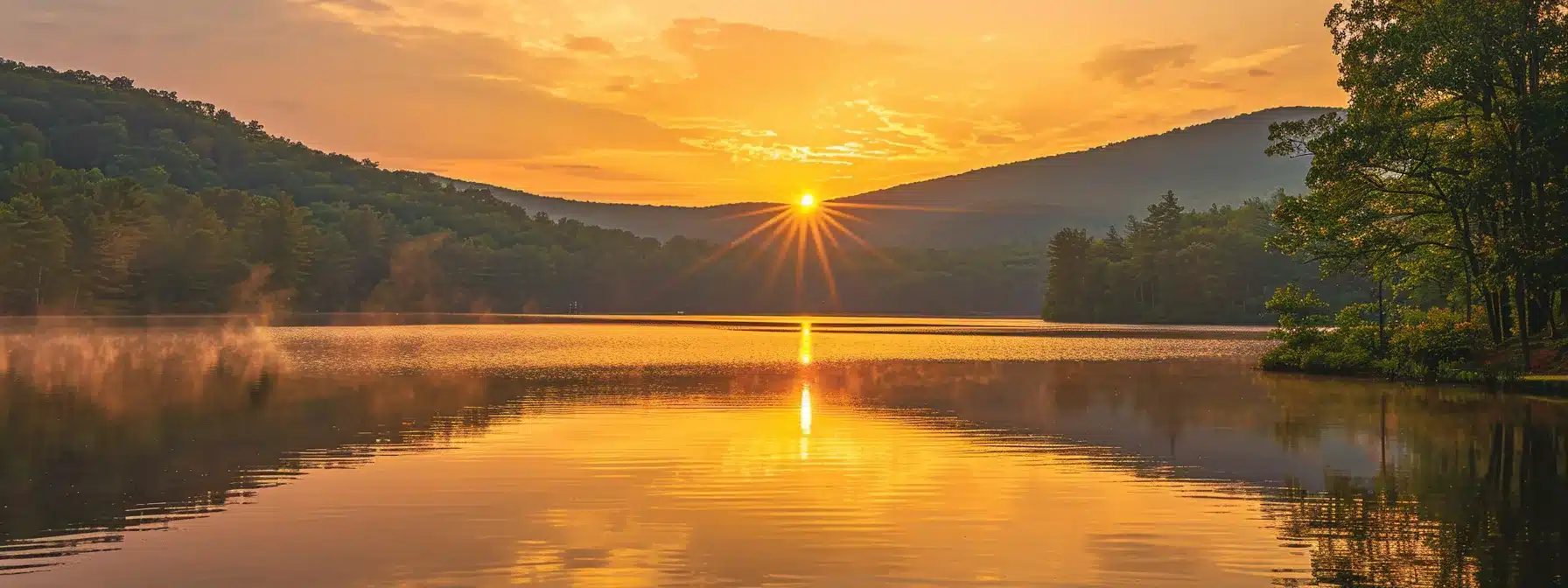 a breathtaking golden sunrise illuminates a serene mountain landscape, casting warm hues over a tranquil lake reflecting the vibrant colors of dawn.