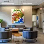 a modern dental office in fort worth, texas, featuring a sleek, inviting reception area with comfortable seating and vibrant, informative posters about affordable root canal options, illuminated by soft, warm lighting.