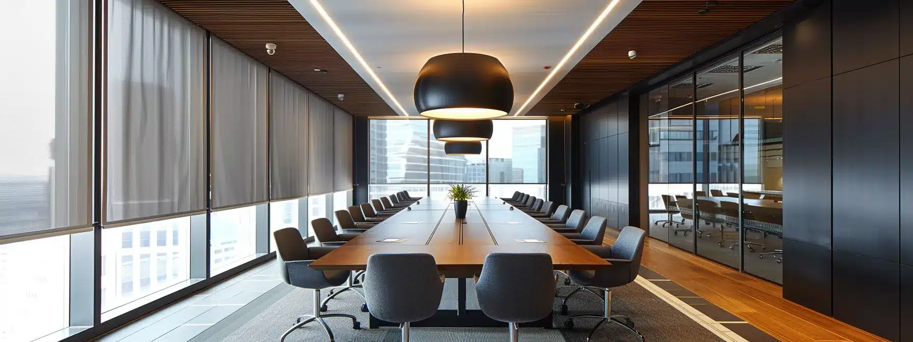 a sleek, modern office space features a large conference table surrounded by high-backed chairs, illuminated by elegant pendant lights, conveying a sense of collaboration and innovation in a dynamic corporate environment.