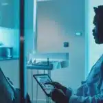 a focused, modern dental clinic scene showcases a confident patient consulting with a specialized dentist over a digital tablet, emphasizing the advanced techniques for dental implants amid a sleek and sterile environment.