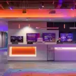 a modern dental clinic in tyler, texas, featuring a welcoming reception area with sleek design elements and promotional signage highlighting affordable dental implants, illuminated by bright, warm overhead lighting.