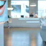a modern dental clinic in tyler, texas, showcasing a welcoming reception area with sleek furniture and informative posters about affordable dentures and implants, illuminated by bright, clean indoor lighting.
