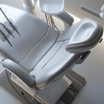 a modern dental clinic in denton, showcasing a sleek consulting room equipped with advanced imaging technology and dental tools, emphasizing a professional atmosphere for discussing implanted denture options and pricing with patients.