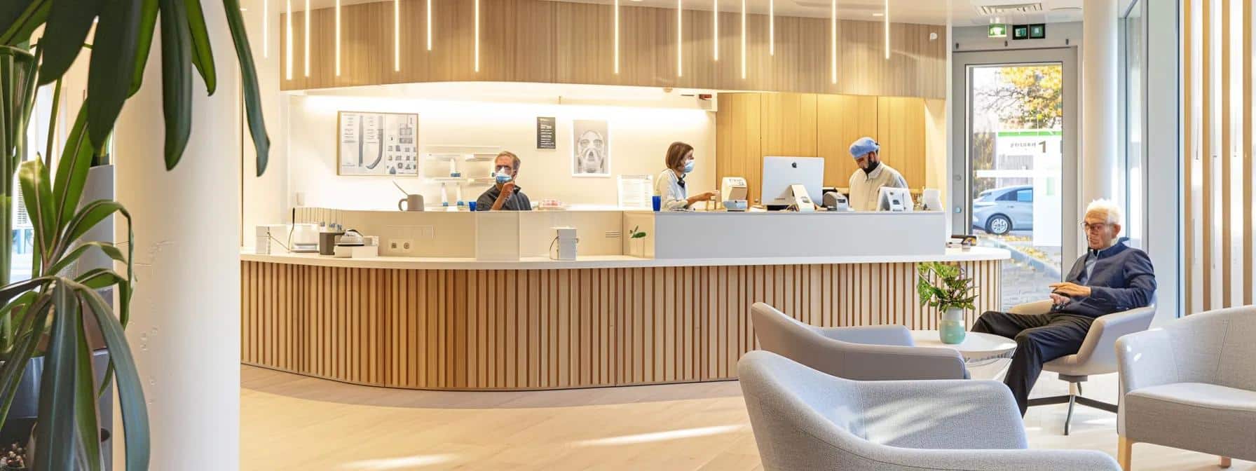 a modern dental clinic interior features a welcoming consultation area where a technician demonstrates the use of a specialized denture cleaning kit to an attentive senior patient, emphasizing the importance of post-repair care and ongoing support in a professional atmosphere.