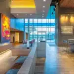 a modern dental clinic interior in lake worth, texas, featuring a sleek reception area with vibrant artwork and welcoming lighting, highlighting the theme of accessible dental care.