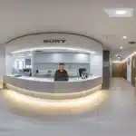 a modern dental clinic is filled with bright, sterile light, showcasing a confident patient smiling after a successful consultation about dental implants, emphasizing the importance of healthy gums for optimal results.