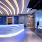 a modern dental clinic in fort worth, texas, featuring sleek, bright interiors and a welcoming reception area, where a smiling patient consults with a professional about an affordable teeth whitening procedure.