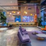 a sleek, modern dental office reception area in mansfield, texas, showcasing a welcoming atmosphere with contemporary decor, comfortable seating, and a vibrant display of dental health brochures.
