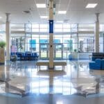 a welcoming dental clinic reception in lake worth, texas, featuring a modern, bright interior with comfortable seating and promotional posters about affordable dentures and implants on the walls, creating an inviting environment for patients seeking dental care.