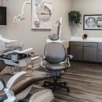 a bright and modern dental clinic in tylet, texas, featuring a welcoming reception area with stylish seating and informative displays highlighting affordable dentures and implants.