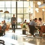 a bustling urban office in fort worth, texas, showcasing a focused team of professionals engaged in a discussion about affordable emergency root cancellation solutions, with sleek technology and contemporary design emphasizing productivity and urgency.