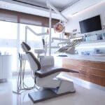 a polished dental clinic with a modern design, featuring a pristine dental chair and advanced imaging equipment, emphasizes the innovative concept of dental implants as a reliable tooth replacement solution.