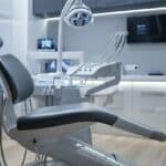 a sleek, modern dental clinic interior showcases a pristine dental chair, surrounded by advanced equipment and digital displays, emphasizing the importance and innovation of single tooth dental implants.