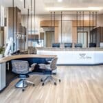 a modern dental clinic in mansfield, texas, featuring sleek, contemporary design elements and a warm, inviting atmosphere, highlighting the reassuring professionalism of affordable denture services.