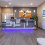 a modern dental clinic in denton, texas, featuring a welcoming reception area with vibrant dental artifacts and comfortable seating, highlighting a professional environment focused on affordable dentures and implants.