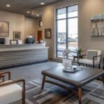 a modern dental clinic reception in grandbury, texas, featuring sleek furnishings and a welcoming atmosphere, with a prominently displayed sign indicating affordable emergency dental services.