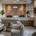a modern dental office in cleburne, texas, featuring a warm and welcoming reception area with inviting decor and soft lighting, showcasing a prominent display highlighting affordable emergency dental services.
