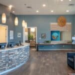 a vibrant dental clinic reception in granbury, texas, features an inviting, modern atmosphere with friendly staff ready to assist patients seeking affordable dentures and implants.