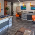 a bustling dental office reception area in lake worth, texas, featuring modern decor, bright colors, and an inviting atmosphere that conveys a sense of accessibility and affordability in dental care.