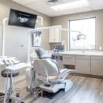 a sharply lit modern dental office interior showcases a focused dental professional analyzing advanced imaging technology, highlighting the urgency of early identification of dental implant issues.