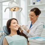 Smiling patient consulting with a dentist about dental implants in a welcoming dental clinic