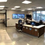 a modern dental clinic in mansfield, tx showcases a state-of-the-art prosthodontics room, featuring an advanced digital imaging station and sleek dental chairs, all designed to provide a seamless, high-tech experience for patients seeking custom denture solutions.