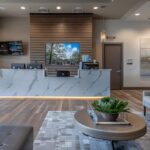 a modern dental clinic in lake worth, tx, showcases a confident patient smiling with their new dental implants, surrounded by sleek, advanced dental technology and a warm, inviting atmosphere.